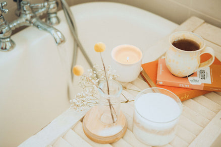 bath set up for at-home spa day with tea and candle