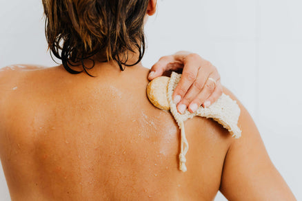 person washing back with bar soap