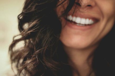 woman smiling with hair over face