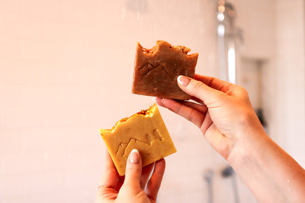 person holding natural soap bars