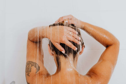 person shampooing and condition hair