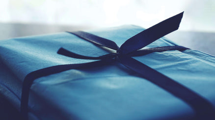 Blue birthday present box with a bow
