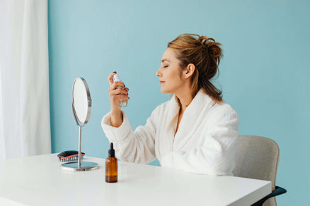 Woman spraying toner on face