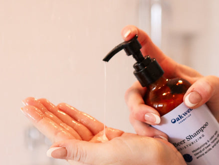 person using Oakwell Cosmetics Shampoo to wash hair