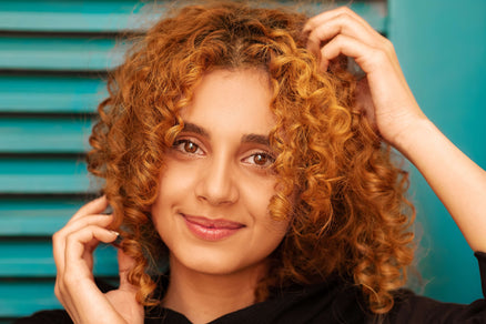 woman touching hair for how to choose the right shampoo