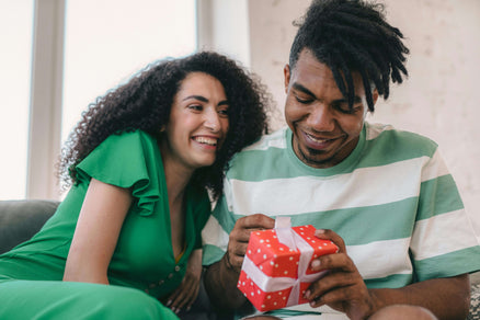 woman giving man a giftbox