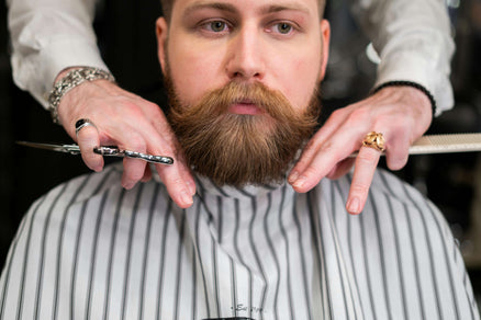 Man getting his beard groomed to stimulate beard growth