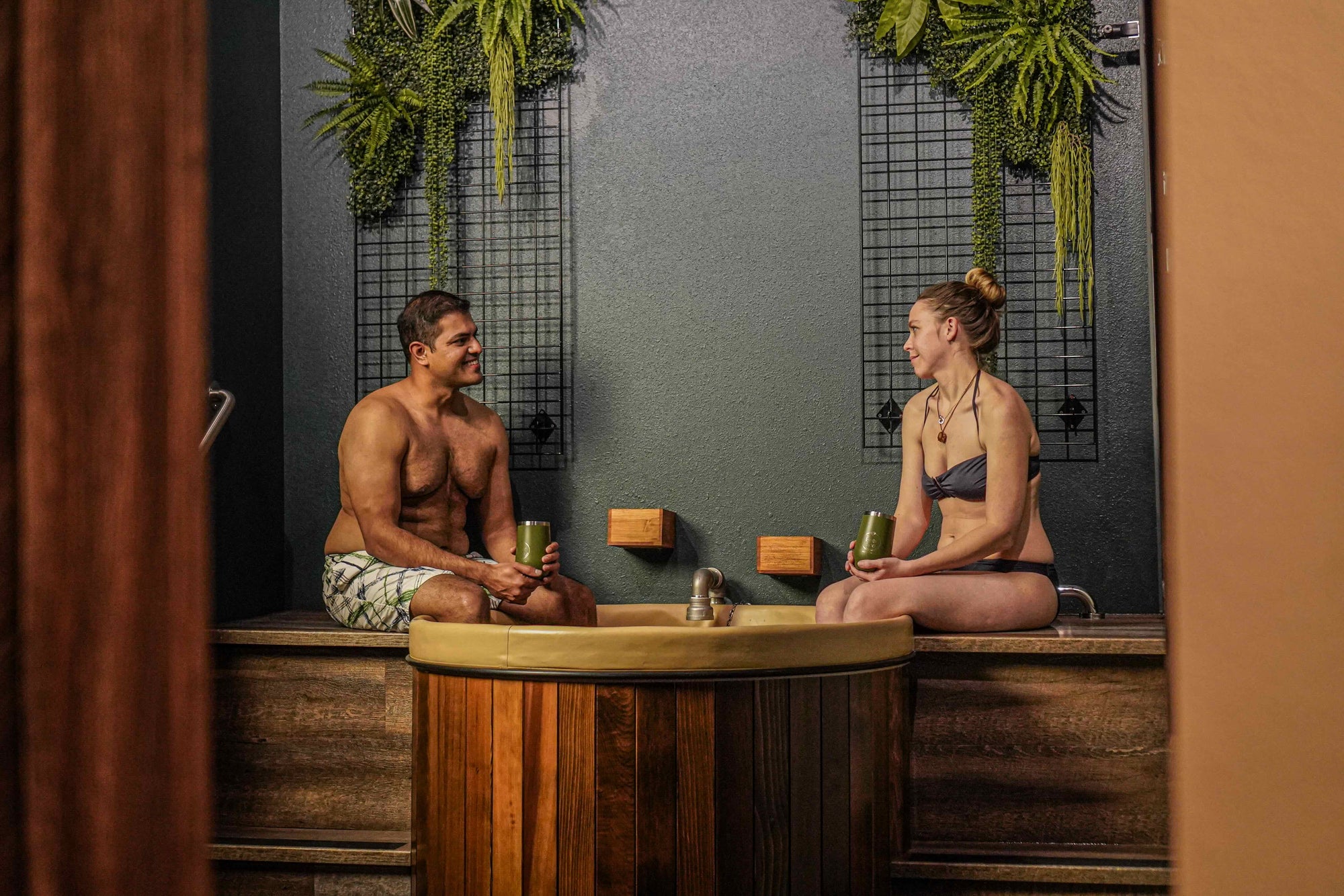 Couple relaxing next to beer bath