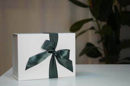 white Father's Day gift box with green ribbon bow