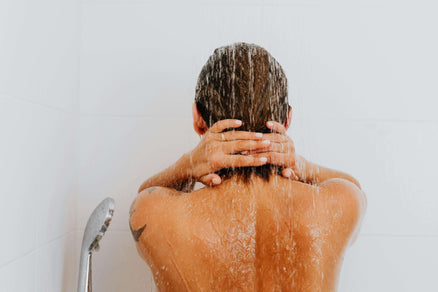 Person washing their hair with back to camera