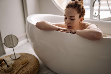 woman taking a bath in bath salts