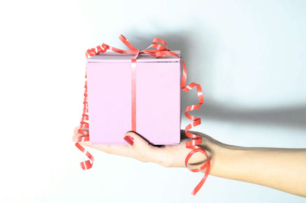 Pink gift box for mom with red ribbon