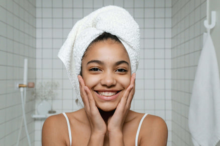 Woman looking in mirror doing skincare routine